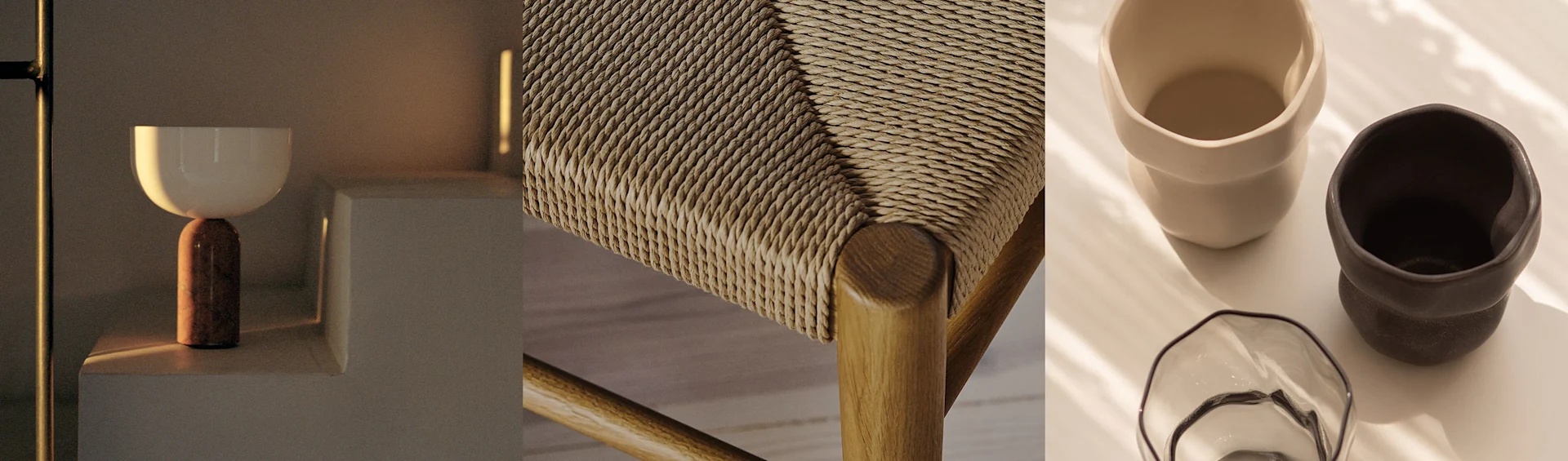 Una lampada moderna, un sedile di sedia intrecciato e due tazze in ceramica con una ciotola di vetro, tutto in toni caldi.